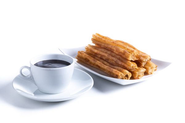 Hot chocolate with churros isolated on white background